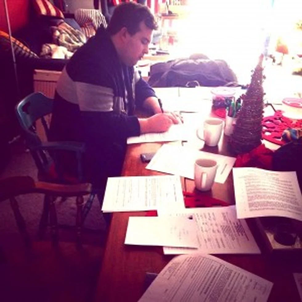 Man sitting at desk filing out paperwork