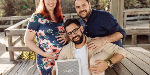 Gay dads with their pregnant surrogate