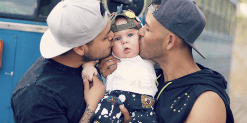 Gay dads kissing their son's face