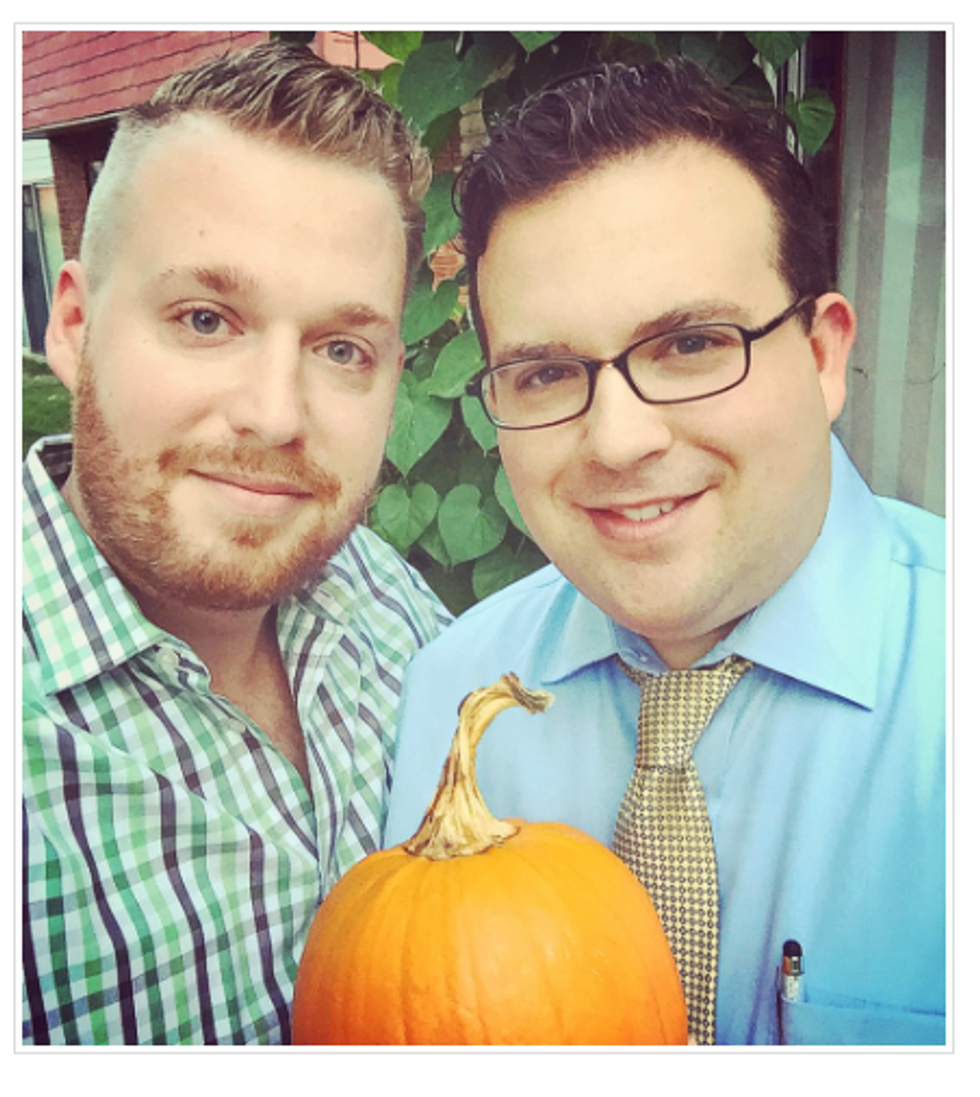 Gay couple holding pumpkin