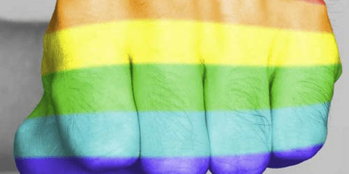 Closed man's fist colored in the rainbow flag
