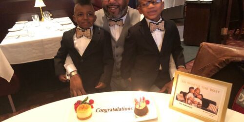 Gay dad and his sons celebrating their adoption day with matching bow ties