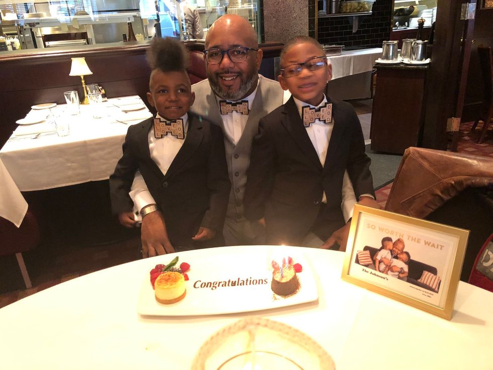 Gay dad and his sons celebrating their adoption day with matching bow ties