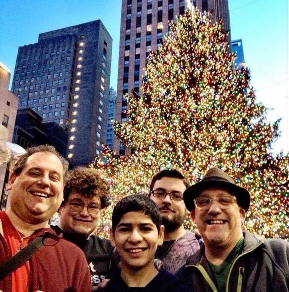 Two dads and their three teenage sons at a Christmas tree lighting