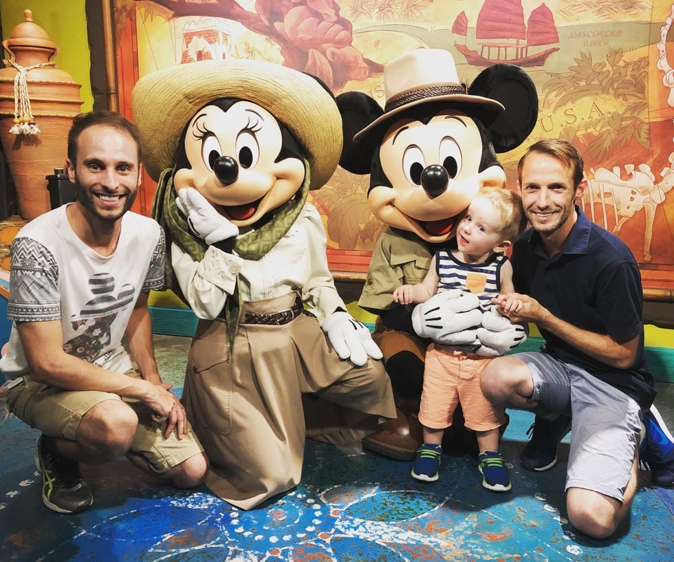 gay couple with their son, Mickey and Minnie Mouse at Disney