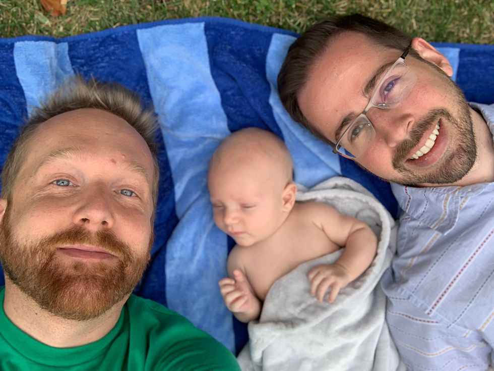 two fathers with their newborn