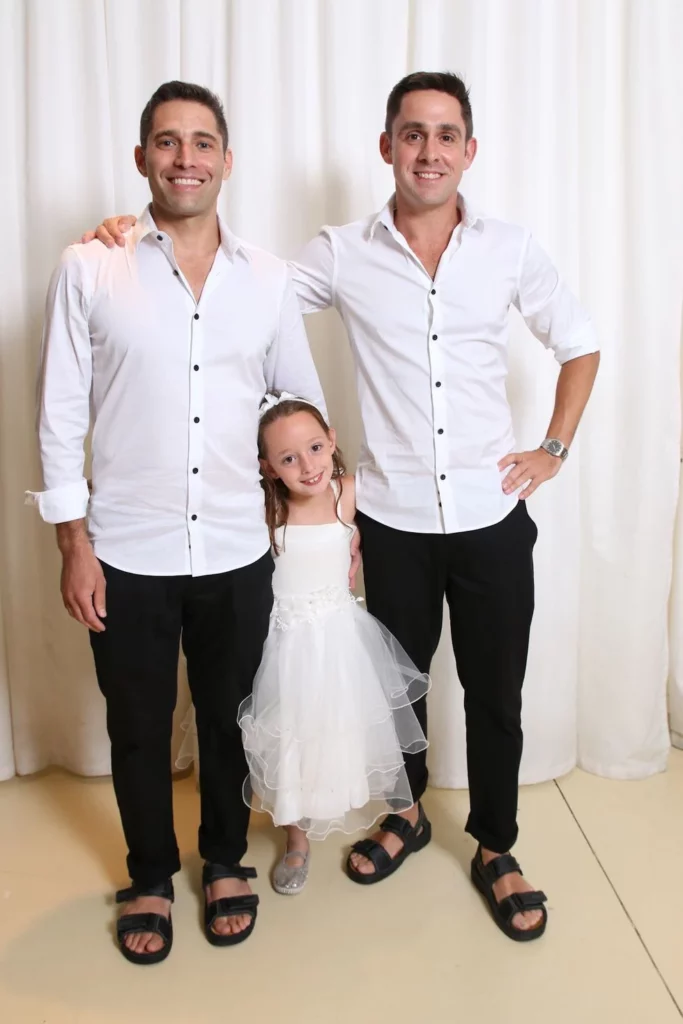 Two dads and a little girl dressed up