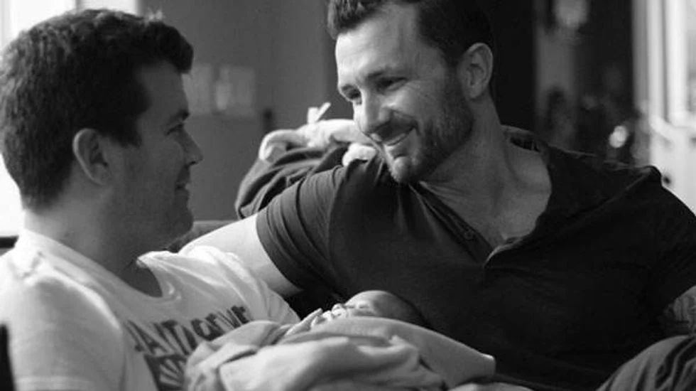 Gay couple with their newborn