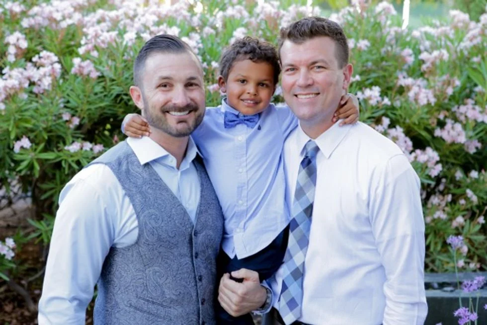 Couple at their wedding with their son
