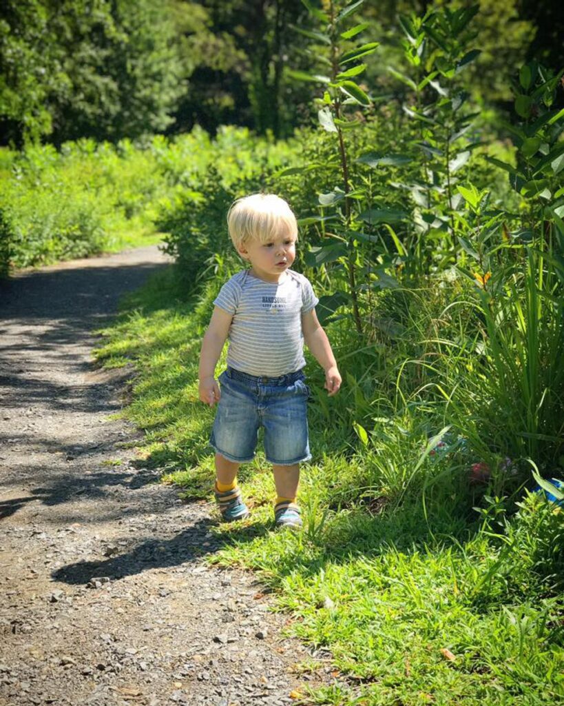 little boy walking on a trail