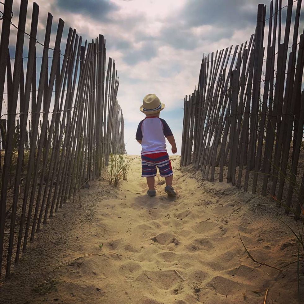little boy walking onto the beach