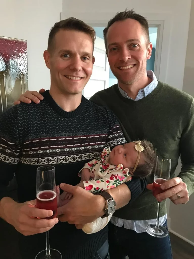 Gay couple toasting arrival of newborn