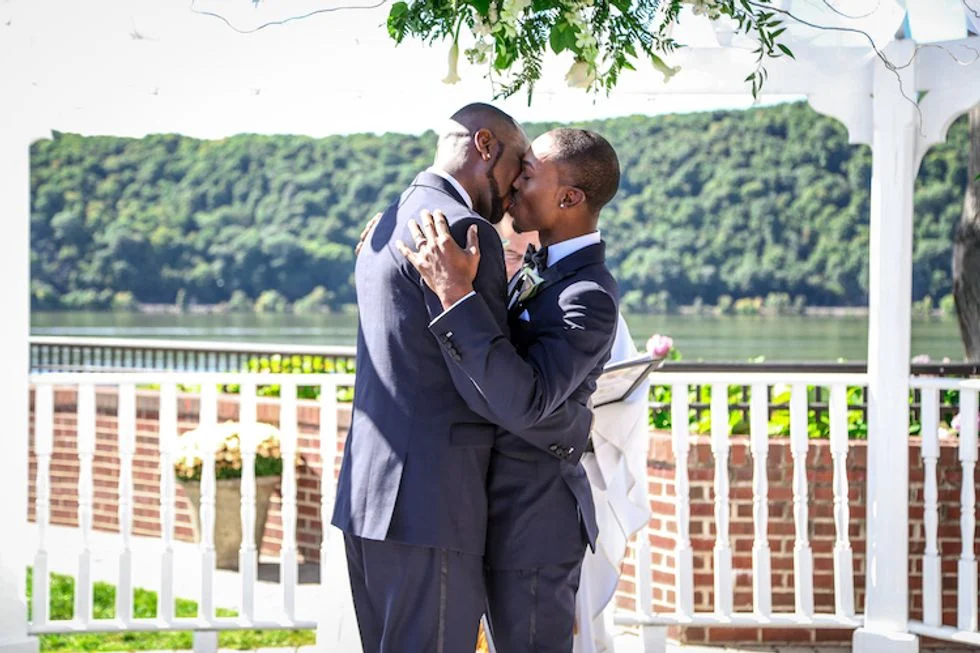 Gay couple kissing on their wedding day