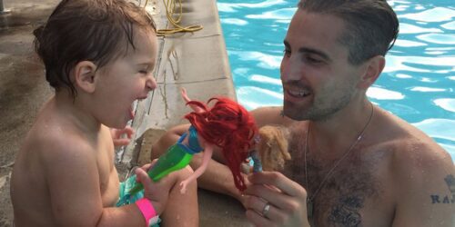 Father and son in a pool with an Ariel doll