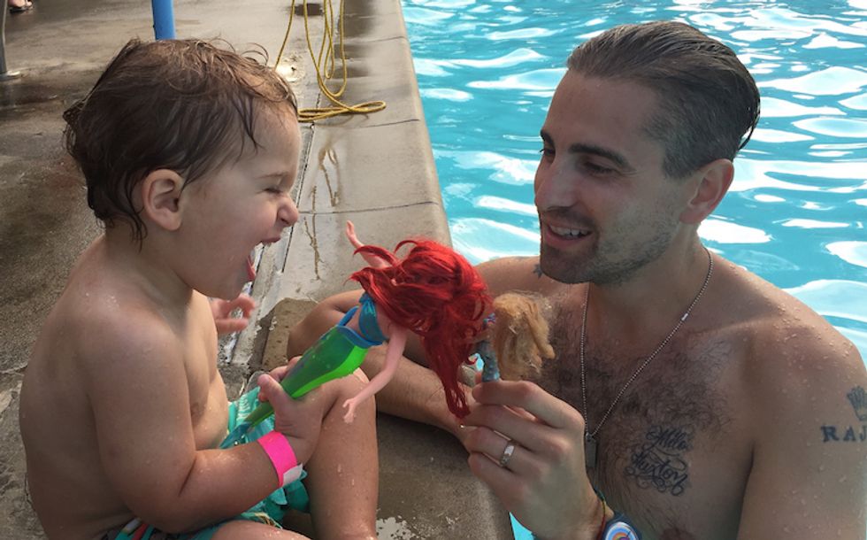 Father and son in a pool with an Ariel doll