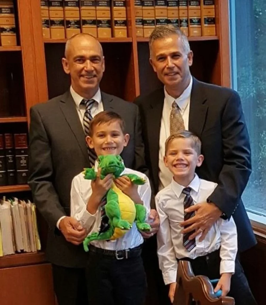 Two foster dads and their sons dressed in shirts and ties