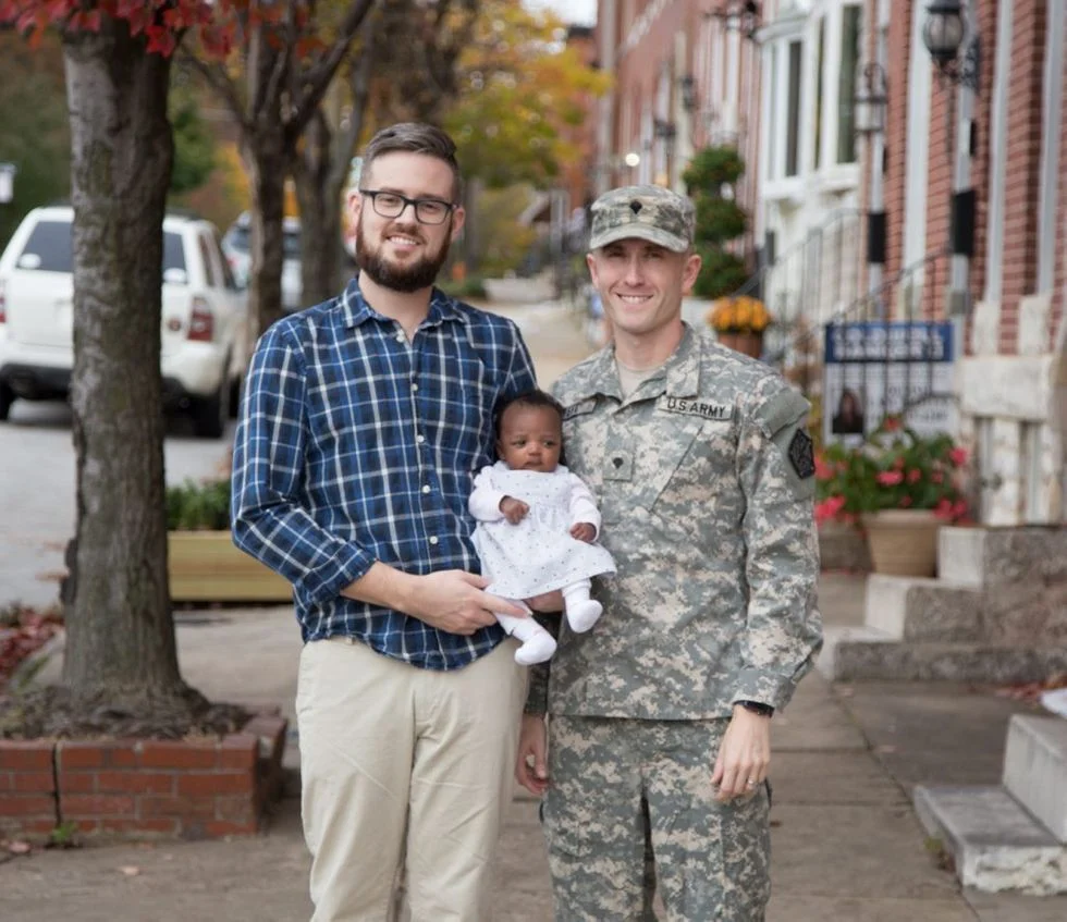 A military family of two dads, one in uniform, and their foster duaghter
