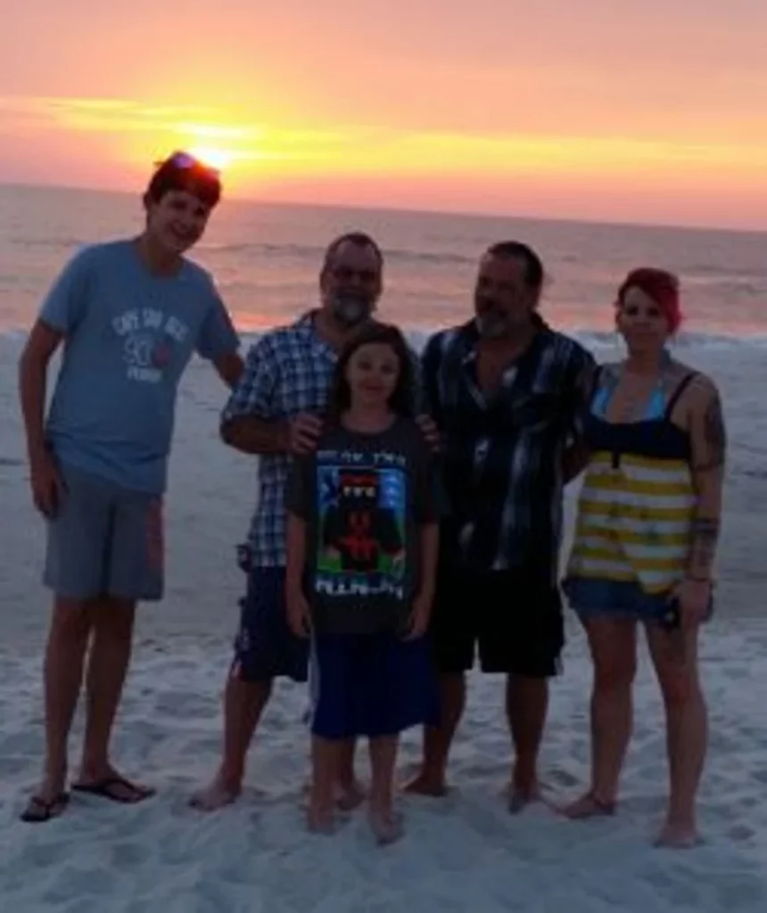 Family of five on the beach at sunset
