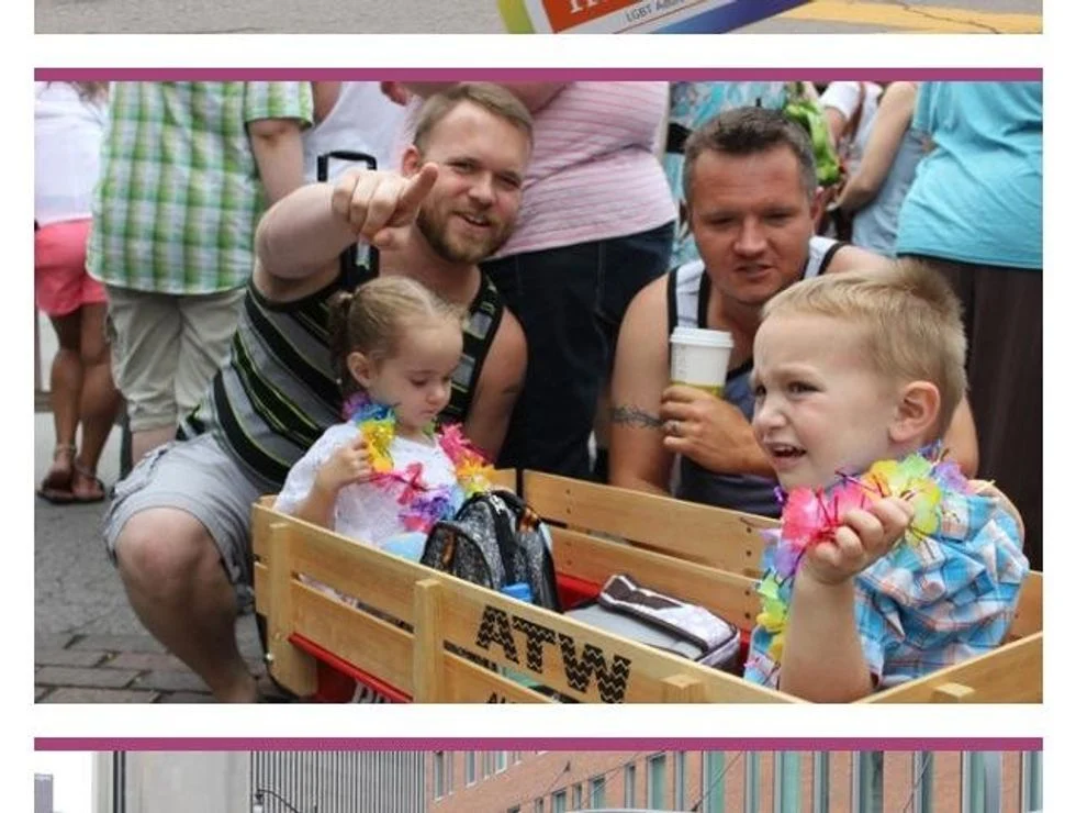 Dad with twins in wagot at Pride parade