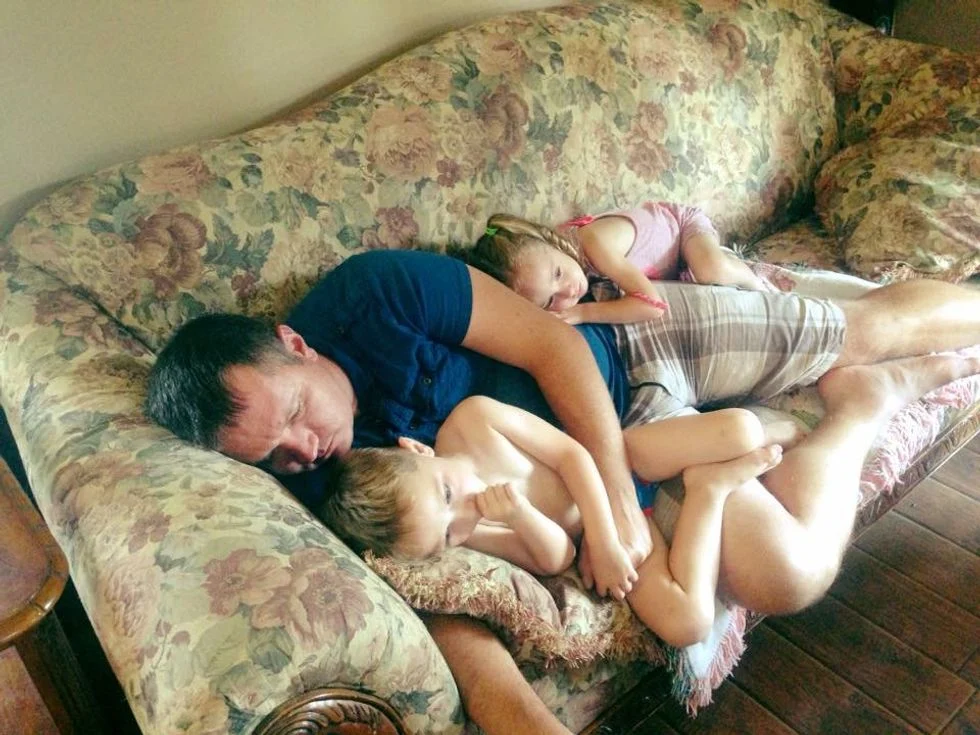 Dad cuddling with children on the couch