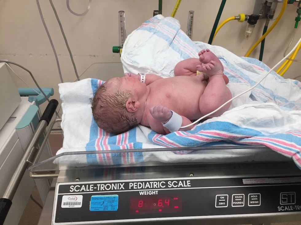newborn on scale