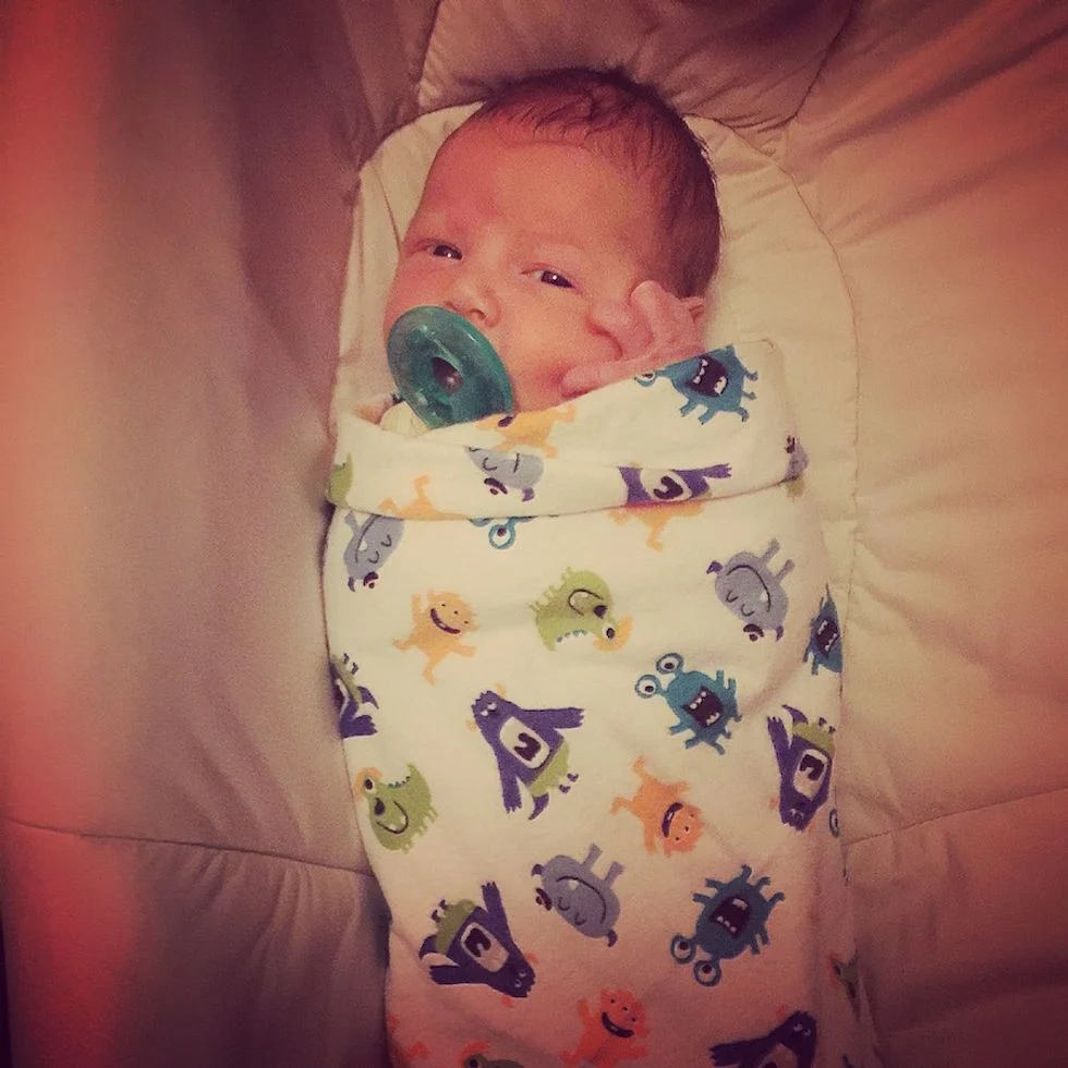newborn baby swaddled in blanket