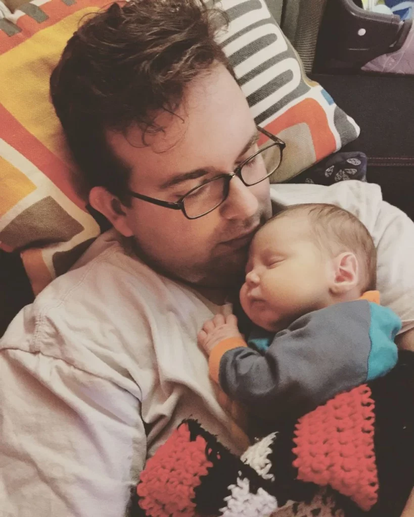 Father cuddling his newborn son
