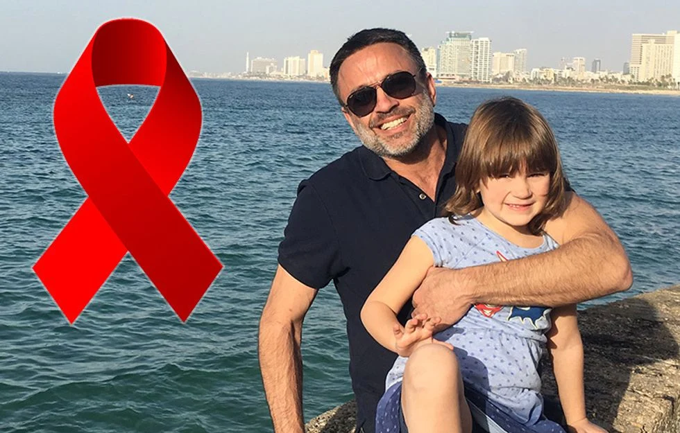 Father posing with his daughter on water's edge with city skyline behind them and a red ribbon on the photo