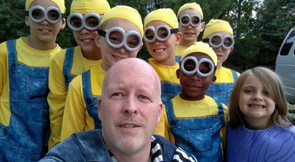 Father and his eight children dressed as Minions