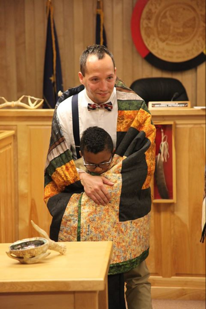 Father and son at wrapping ceremony at adoption