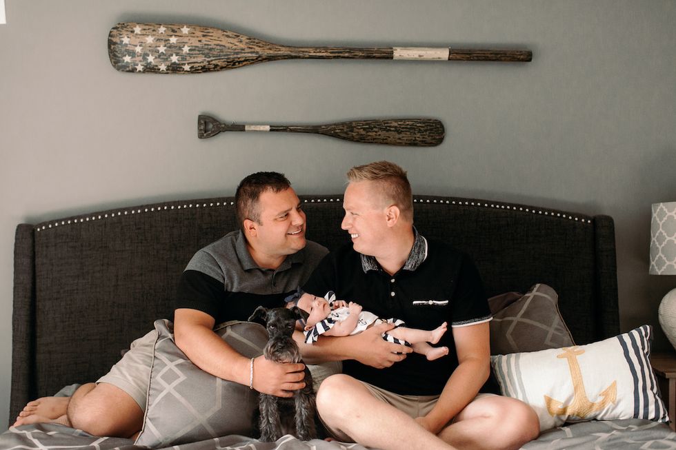Gay couple posing with newborn