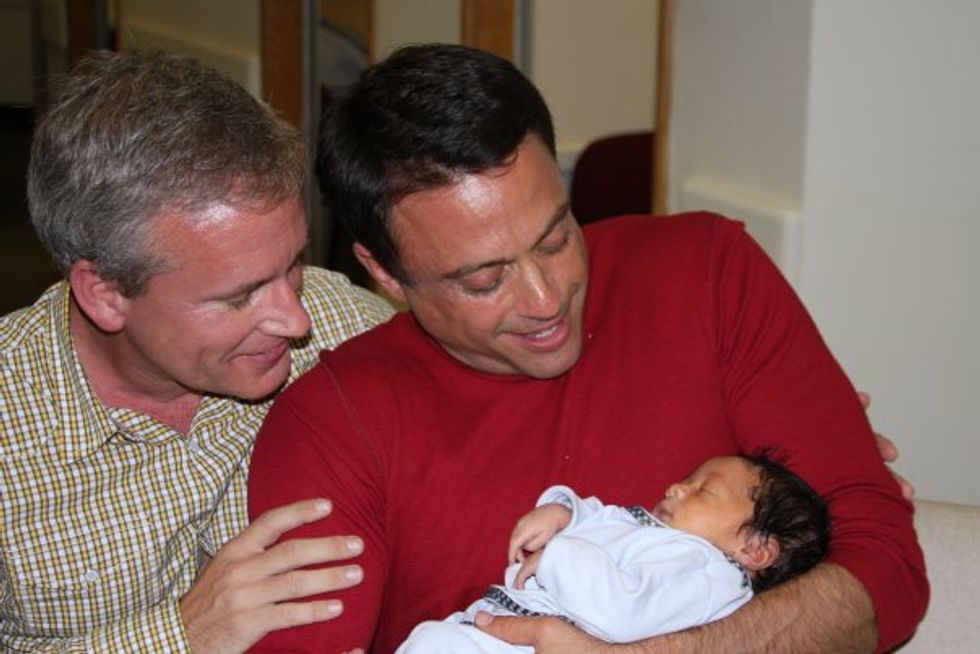 Two fathers and their newborn son