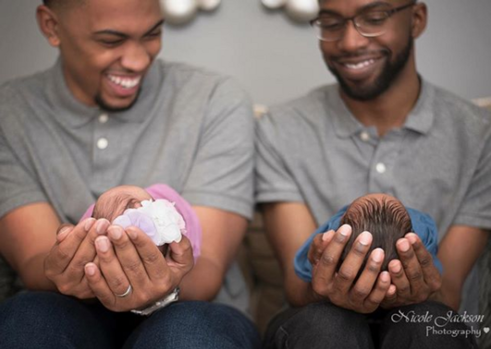 Black couple holding their newborn twins
