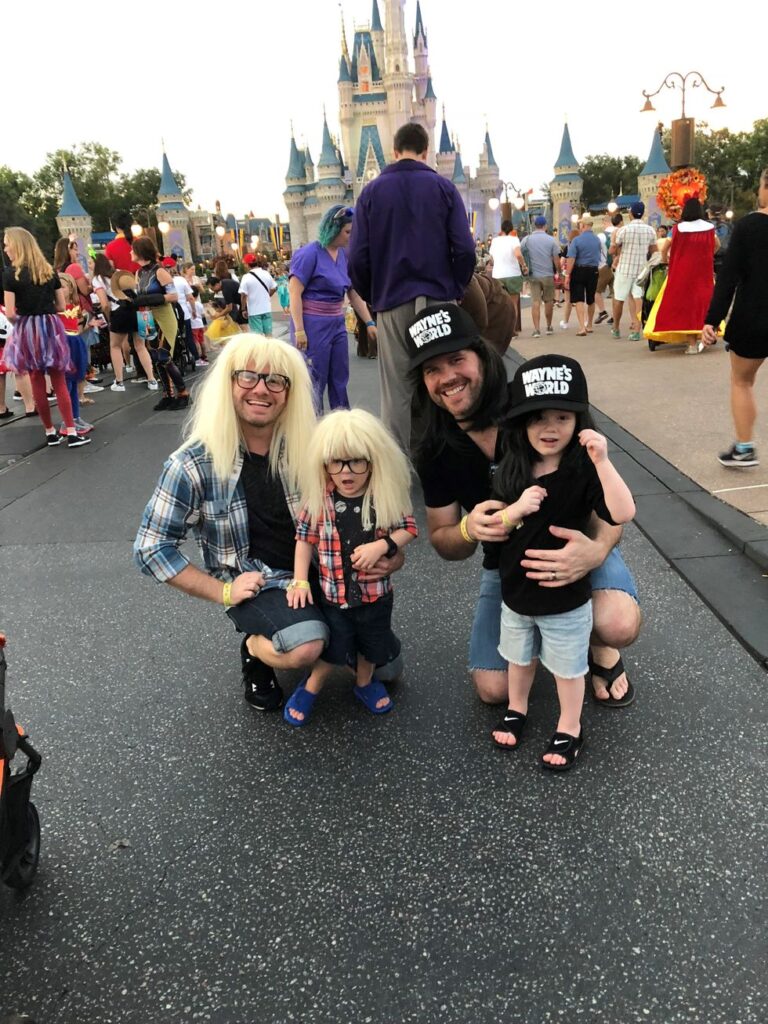 Two fathers and their sons dressed up as Wayne's World at Disney