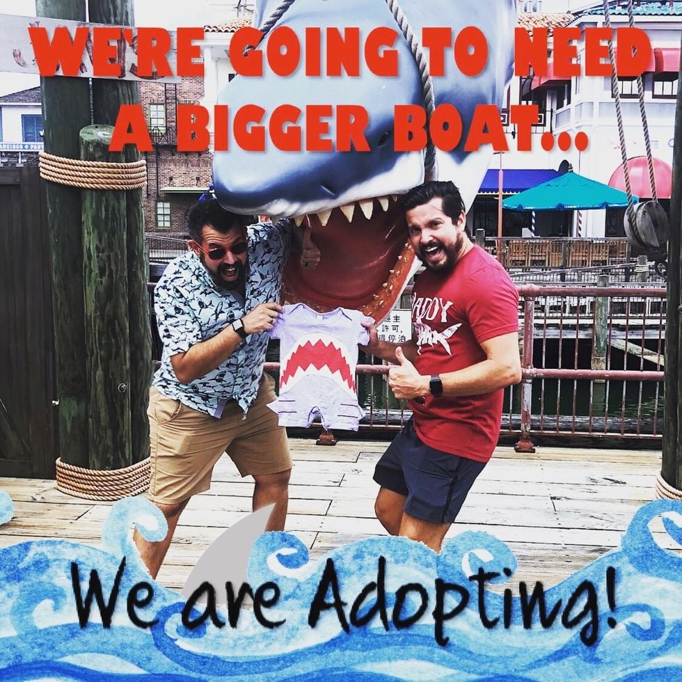 couple with their baby announcement