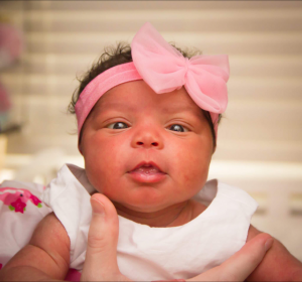beautiful newbown baby girl with pink bow