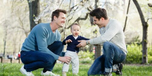 Gay couple with their son on the lawn