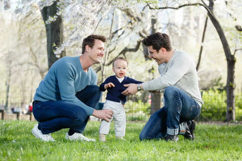 Gay couple with their son on the lawn