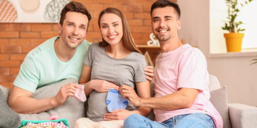 Gay dads and their pregnant surrogate